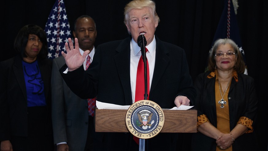 President Donald Trump speaks after touring of the National Museum of African American History and Culture, Tuesday, Feb. 21, 2017, in Washington. From left are, Candy Carson, Housing and Urban Develo ...