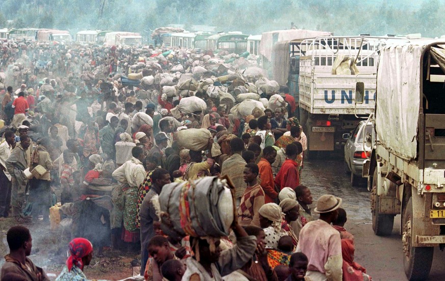 Rwandan Hutu refugees staying at the Mukaruka transit camp wait for transport to Kigali in this November 19, 1996 file photo. April 7, 2014 marks the 20th anniversary of the Rwanda genocide which kill ...