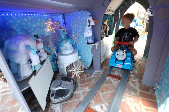 Micah McArthur, 6, rides through Sleeping Princess Castle, inspired by Disneyland&#039;s Sleeping Beauty Castle, in his grandfather&#039;s Fullerton backyard on June 1, 2016. 

Steve Dobbs, a former B ...