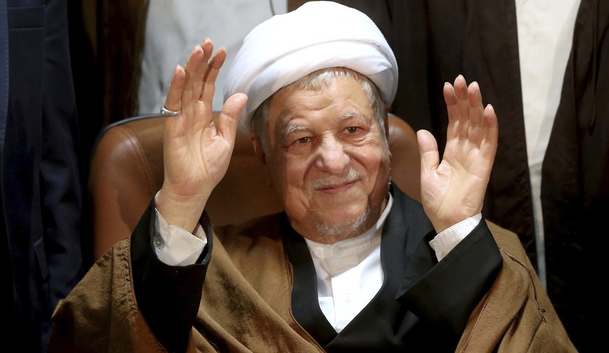 FILE -- In this Dec. 21, 2015 file photo, former Iranian President Akbar Hashemi Rafsanjani waves to journalists as he registers his candidacy for the elections of the Experts Assembly, in Tehran, Ira ...