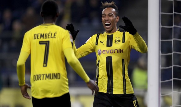 Dortmund&#039;s scorer Ousmane Dembele, left, and his teammate Pierre-Emerick Aubameyang celebrate their side&#039;s 5th goal during the German Bundesliga soccer match between Hamburger SV and Borussi ...