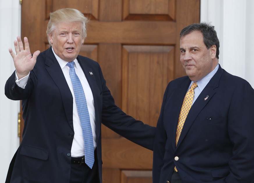 FILE - In this Nov. 20, 2016 file photo, then President-elect Donald Trump, left, waves to the media as New Jersey Gov. Chris Christie arrives at the Trump National Golf Club Bedminster clubhouse, in  ...