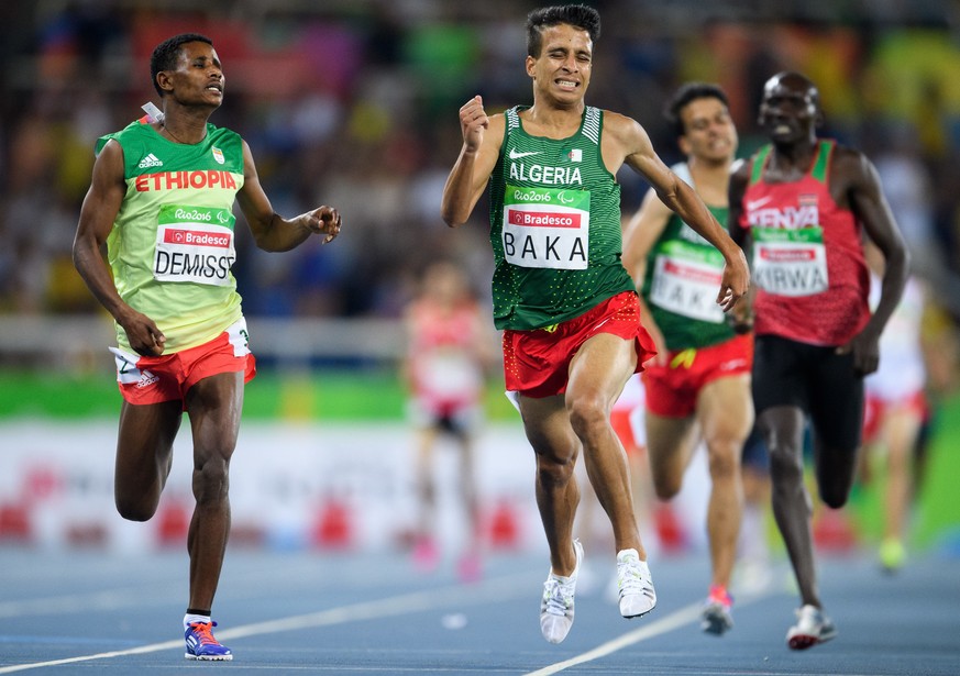 In this Sunday, Sept. 11, 2016 photo released by IOC, Algeria&#039;s Abdellatif Baka narrowly wins the gold ahead of Ethiopia&#039;s Tamiru Demisse in the men&#039;s 1,500-meter T13 final athletics ev ...