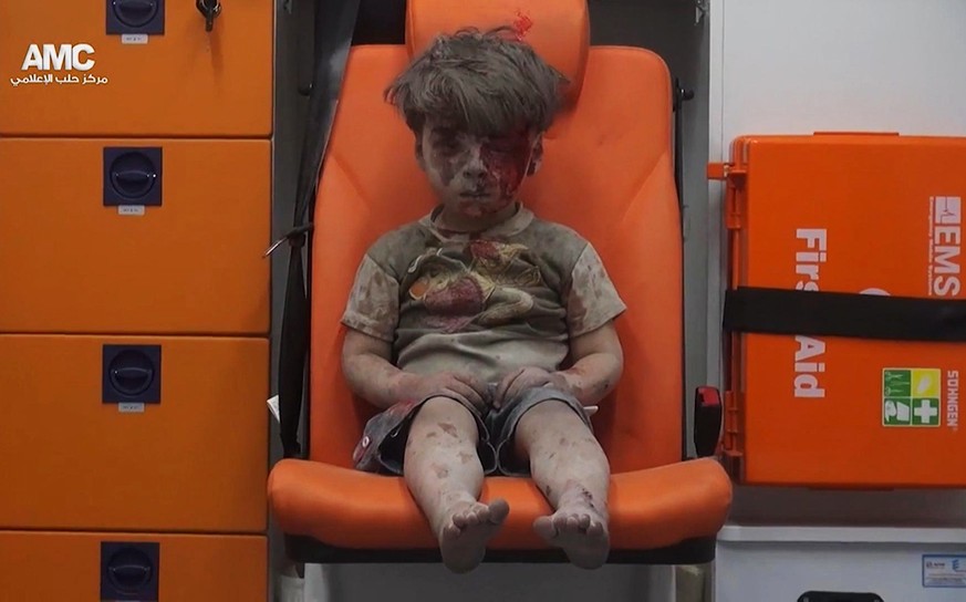 FILE --In this Aug. 17, 2016 file frame grab taken from video provided by the Syrian anti-government activist group Aleppo Media Center (AMC), 5-year-old Omran Daqneesh sits in an ambulance after bein ...