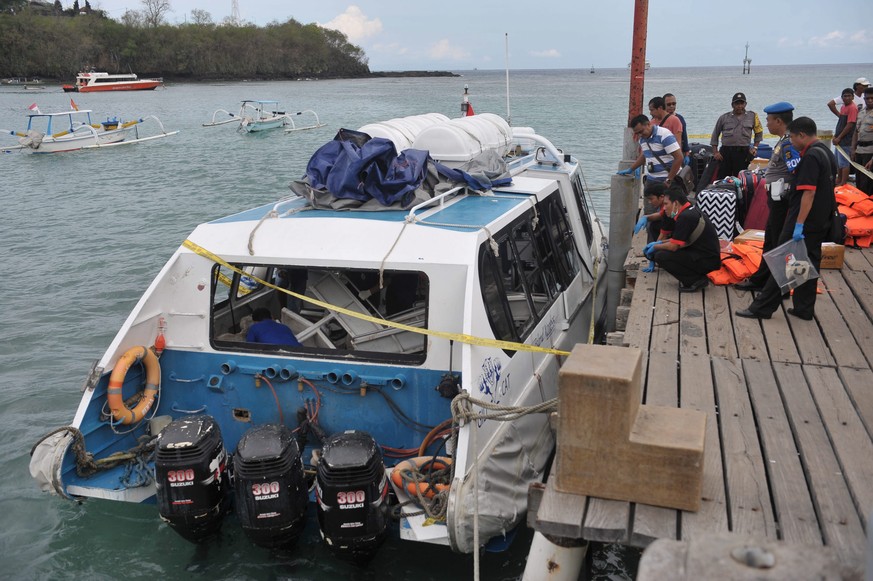 epa05540316 Indonesian police investigate the exploded tourist boat at Padang Bai port in eastern Bali, Indonesia, 15 September 2016. A tourist fast boat, Gili Cat 2, exploded after departing from Pad ...