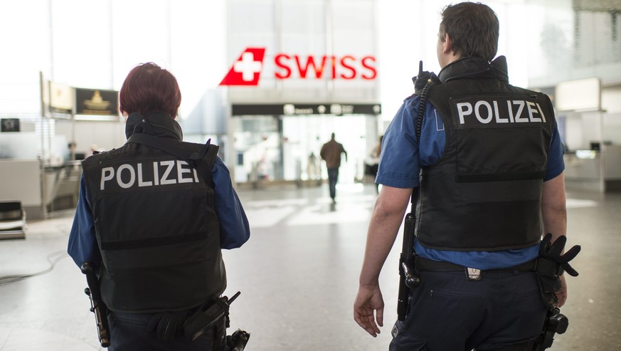 epa05225734 Police officers indicate their presence at the Airport of Zurich, in Zurich-Kloten, Switzerland, 22 March 2016. All flights to brussels are canceled and security measures have been raised  ...