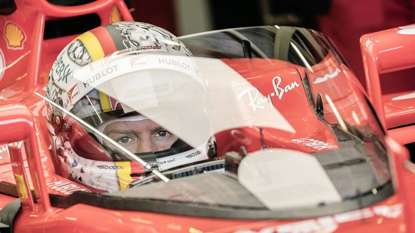 epa06086499 German Formula One driver Sebastian Vettel of Scuderia Ferrari sits in his car during the first practice session of the Formula One Grand Prix of Great Britain at the Silverstone circuit,  ...