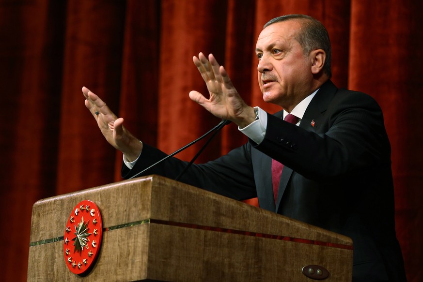 Turkey President Recep Tayyip Erdogan delivers a speech commenting on those killed and wounded during a failed July 15 military coup, in Ankara, Turkey, late Friday, July 29, 2016. The government crac ...