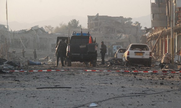 epa05626233 Afghan security officials inspect the scene of multiple suicide bombing that targeted the German consulate in Mazar-e-Sharif, Afghanistan, 11 November 2016. At least four people including  ...