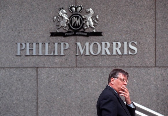 ROME REQUEST--FILE--An unidentified man take a cigarette break outside the headquarters of Philip Morris in New York, Wednesday, May 15, 1996 (AP Photo/File,Chris Kasson)