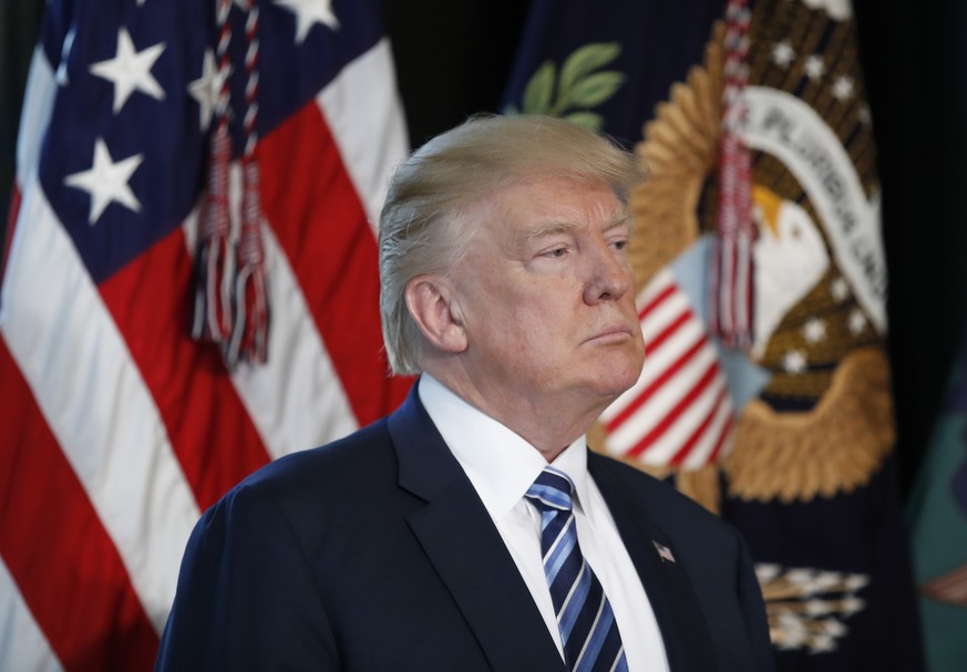 FILE - In this Friday, April 21, 2017, file photo, President Donald Trump listens as Treasury Secretary Steve Mnuchin speaks at the Treasury Department in Washington. Trump won the White House by argu ...