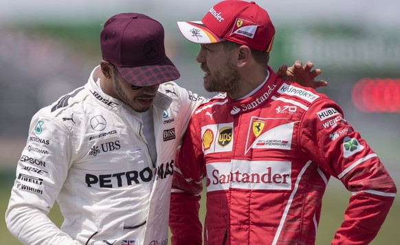 epa06021571 British Formula One driver Lewis Hamilton of Mercedes AMG GP (L) talks to German Formula One driver Sebastian Vettel of Scuderia Ferrari (R) after the qualifying session of Canada Formula  ...