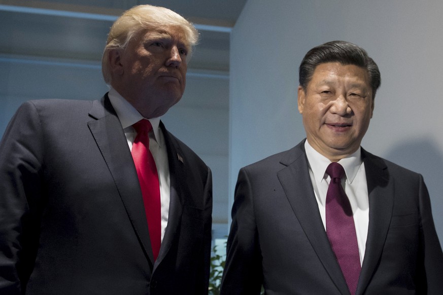 US President Donald Trump and Chinese President Xi Jinping, right, arrive for a meeting on the sidelines of the G-20 Summit in Hamburg, Germany, Saturday, July 8, 2017. (Saul Loeb/Pool Photo via AP)