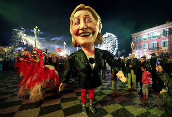 A giant figure of French National Front leader Marine Le Pen is paraded through the crowd during the 133rd Nice Carnival parade, the first major event since the city was attacked during Bastille Day c ...