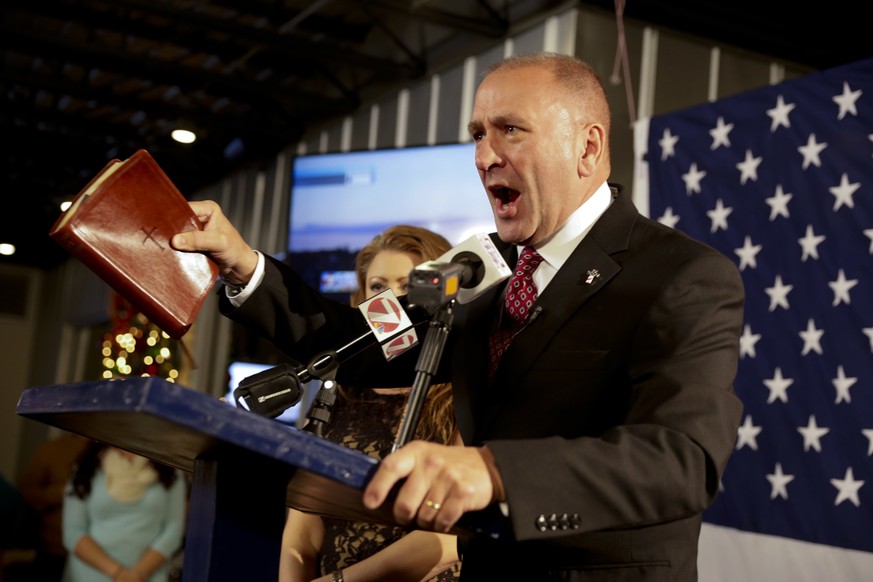 FILE - In this Dec. 10, 2016, file photo, Republican candidate Clay Higgins, with his wife, Becca, addresses supporters after his victory in Louisiana&#039;s 3rd congressional district run-off electio ...