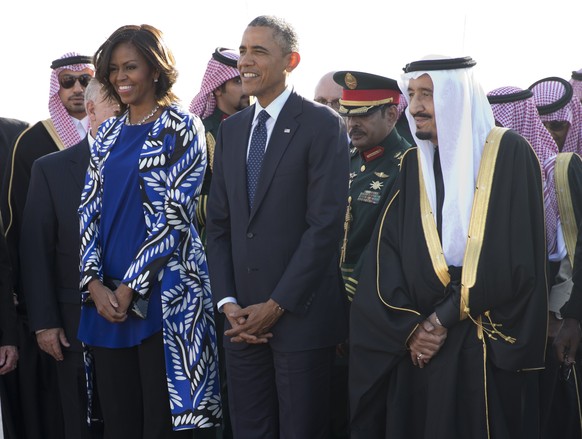 FILE - In this Jan. 27, 2015 file photo, President Barack Obama and first lady Michelle Obama stand with new Saudi King Salman bin Abdul Aziz they arrive on Air Force One at King Khalid International  ...