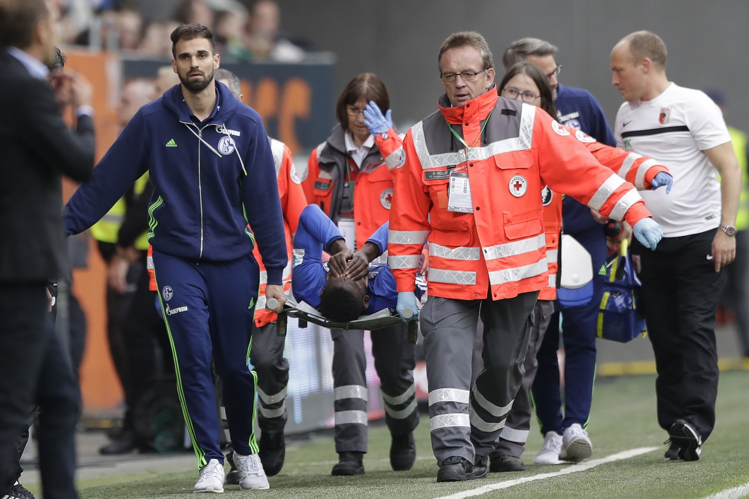 Schalke's Breel Embolo leaves the field on a stretcher during the German Bundesliga soccer match between FC Augsburg and FC Schalke 04 in Augsburg, Germany, Saturday, Oct. 15, 2016. (AP Photo/Mat ...