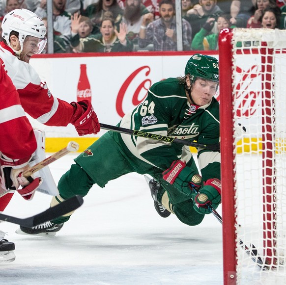 Feb 12, 2017; Saint Paul, MN, USA; Minnesota Wild forward Mikael Granlund (64) scores a goal in front of Detroit Red Wings defenseman Nick Jensen (3) during the first period at Xcel Energy Center. Man ...