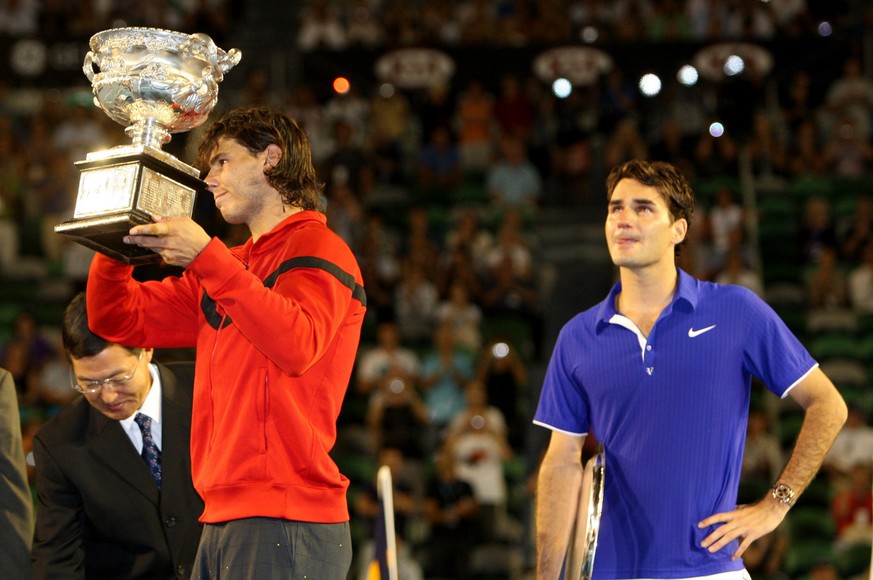 Spain&#039;s Rafael Nadal, left, holds the trophy next to runner-up Switzerland&#039;s Roger Federer during the awarding ceremony of the Men&#039;s singles final match at the Australian Open Tennis Ch ...