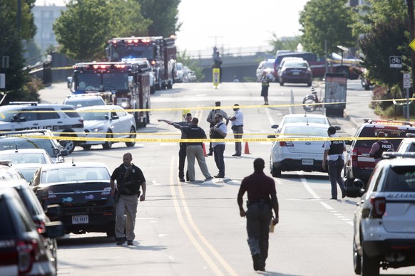 epa06027738 First responders on the scene following a shooting in Alexandria, Virginia, USA, 14 June 2017. The Republican House majority whip Steve Scalise and at least four others have been shot shot ...