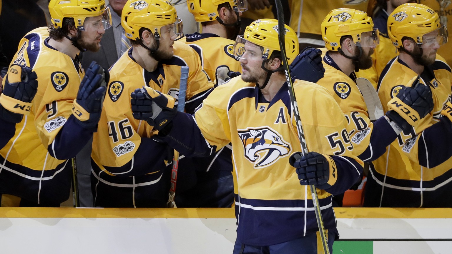 Nashville Predators defenseman Roman Josi (59), of Switzerland, is congratulated after scoring the go-ahead goal during the third period in Game 3 of the Western Conference final in the NHL hockey Sta ...
