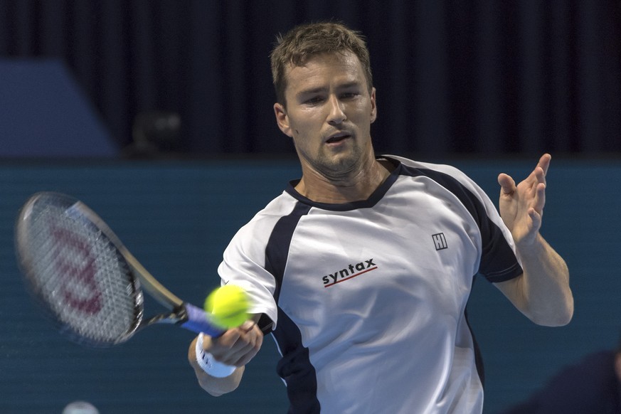 Switzerland&#039;s Marco Chiudinelli returns a ball to Netherlands&#039; Robin Haase during their first round match at the Swiss Indoors tennis tournament at the St. Jakobshalle in Basel, Switzerland, ...