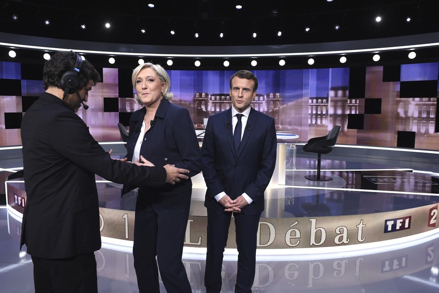 French presidential election candidate for the far-right Front National party, Marine Le Pen, 2nd left, and French presidential election candidate for the En Marche ! movement, Emmanuel Macron, right, ...