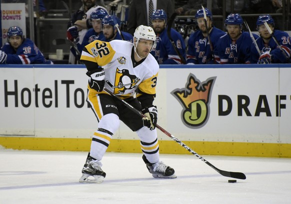 Pittsburgh Penguins defenseman Mark Streit skates with the puck during the first period of an NHL hockey game against the New York Rangers Sunday, April 9, 2017, at Madison Square Garden in New York.  ...