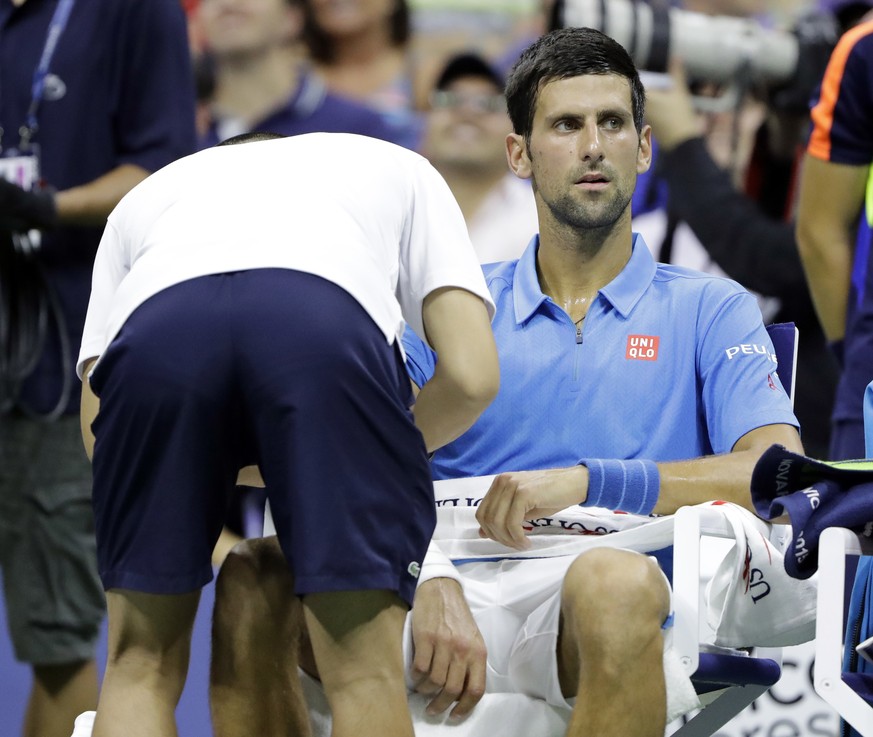 Novak Djokovic, of Serbia, get medical attention during his first round match against Jerzy Janowicz, of Poland, at the US Open tennis tournament, Monday, Aug. 29, 2016, in New York. (AP Photo/Darron  ...
