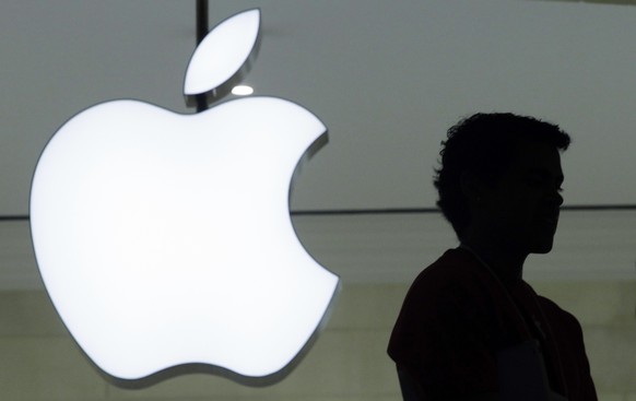 FILE - In this Wednesday, Dec. 7, 2011 file photo, a person stands near the Apple logo at the company&#039;s store in Grand Central Terminal, in New York. Apple appears poised to unveil a voice-activa ...