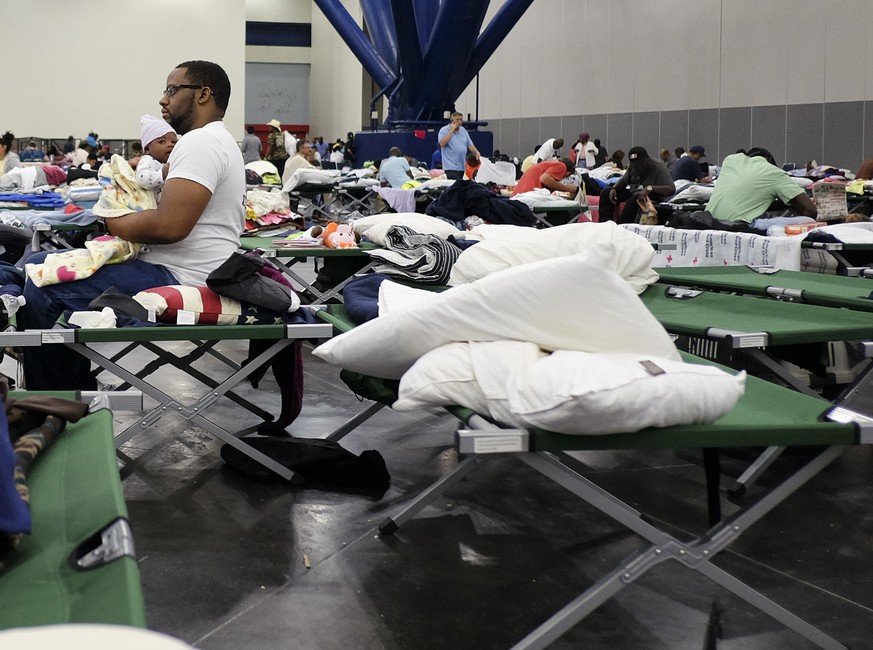 People displaced by Tropical Storm Harvey take shelter in the George R. Brown Convention Center in Houston as Tropical Storm Harvey inches its way through the area on Tuesday, Aug. 29, 2017. (Elizabet ...