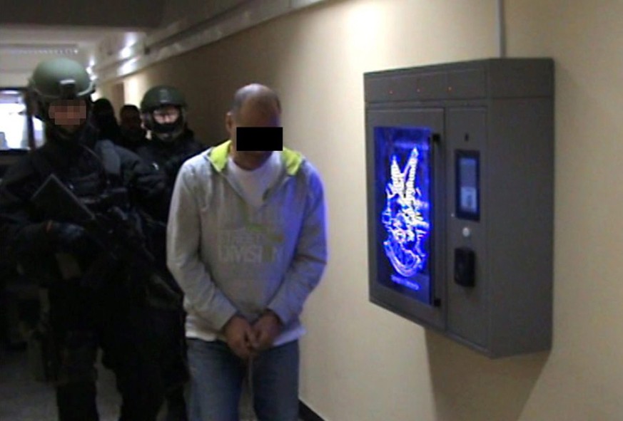 epa05721375 A handout photo made available by the Polish Central Bureau of Police Investigation (CBSP) on 16 January 2017 shows a member of the Italian Camorra being arrested by the Central Bureau of  ...