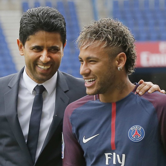 Brazilian soccer star Neymar walks away with the chairman of Paris Saint-Germain Nasser Al-Khelaifi, left, following a press conference in Paris Friday, Aug. 4, 2017. Neymar arrived in Paris on Friday ...