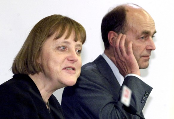German Christian Democratic Party Chairwoman Angela Merkel, left, defenses General Secretary Laurenz Meyer, right, during a news conference after a party presidency meeting in Berlin Monday, Jan. 29, ...