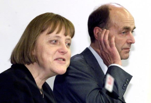 German Christian Democratic Party Chairwoman Angela Merkel, left, defenses General Secretary Laurenz Meyer, right, during a news conference after a party presidency meeting in Berlin Monday, Jan. 29,  ...