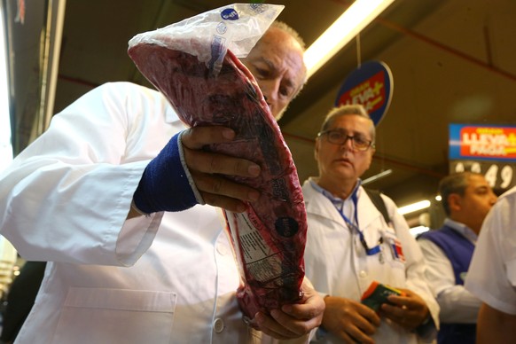 A member of the Public Health Surveillance Agency inspects beef at a supermarket after the Chilean government suspended all meat and poultry imports from Brazil, in Santiago, Chile March 23, 2017. REU ...