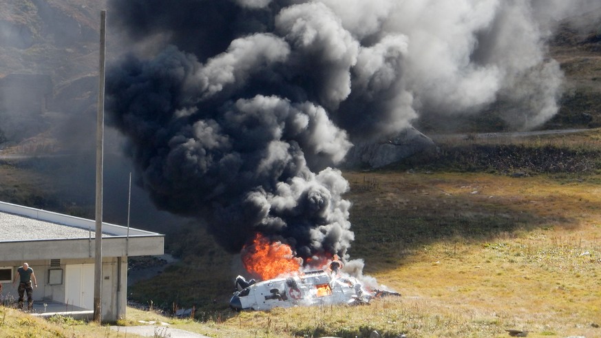 The burning debris oft the crashed Swiss army helicopter in alps near the fort Sasso da Pigna near the Gotthard mountain pass in Airolo, southern Switzerland on Wednesday September 28, 2016. The accid ...