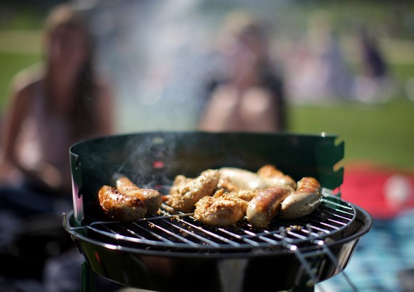 epa02665963 Sausages lie on a grill in a park in Cologne, Germany, 02 April 2011. Germans are enthusiastic about their version of barbecue, grilling, especially between spring and summertime. EPA/ROLF ...