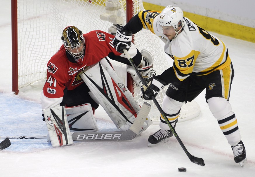 Pittsburgh Penguins center Sidney Crosby (87) controls the puck as Ottawa Senators goalie Craig Anderson (41) defends during the first period of Game 4 of the NHL hockey Stanley Cup Eastern Conference ...