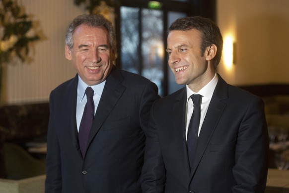 French centrist politician Francois Bayrou, left, and candidate for the 2017 French presidential election, Emmanuel Macron, pose for photographers after a meeting, in Paris, Thursday, Feb. 23, 2017. O ...