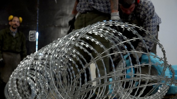 Prison inmates are manufacturing razor wire used on the fences Hungary has built on its borders with Serbia and Croatia to stop the flow of migrants and refugees, in Marianosztra, Hungary, Wednesday,. ...