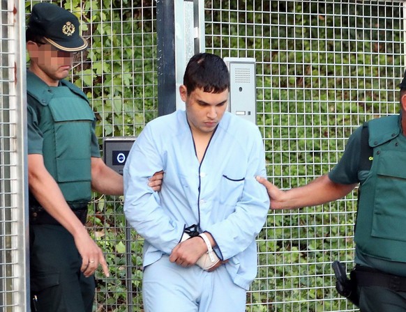 epa06155721 Mohamed Houli Chemlal, one of four arrested in relation to the terrorist attacks in Catalonia, is taken to the Audiencia Nacional court in Madrid, Spain, 22 August 2017. The four suspects  ...