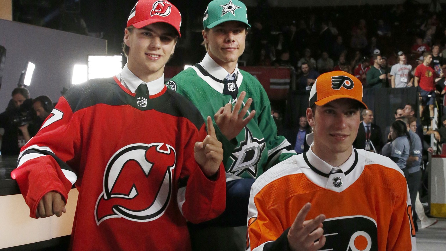 New Jersey Devils daft pick Nico Hischier, left, Dallas Stars pick Miro Heiskanen, center, and Philadelphia Flyers pick Nolan Patrick pose for photos after being selected during the first round of the ...