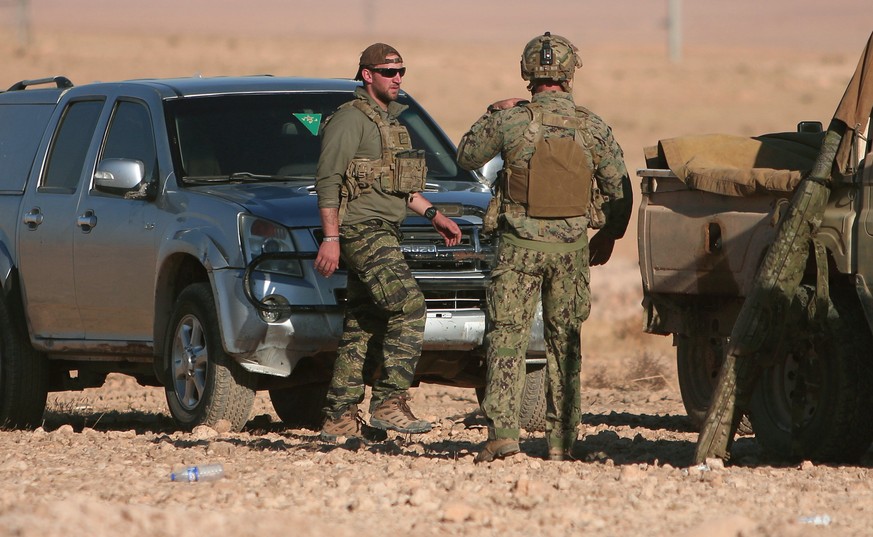 U.S. fighters stand near military vehicles, north of Raqqa city, Syria November 6, 2016. REUTERS/Rodi Said