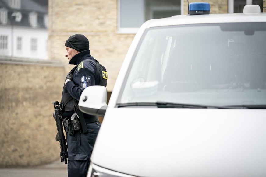 epa09045804 A police offcer stands guard in front of the court in Holbaek, Denmark, 02 March 2021, as the custody of seven people suspected of planning one or more terrorist attacks in Denmark or Germ ...