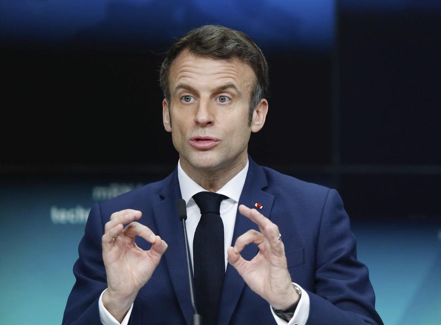 French President Emmanuel Macron speaks during a media conference at an EU Africa summit in Brussels, Friday, Feb. 18, 2022. European Union leaders on Thursday lauded the bloc's vaccine cooperati ...