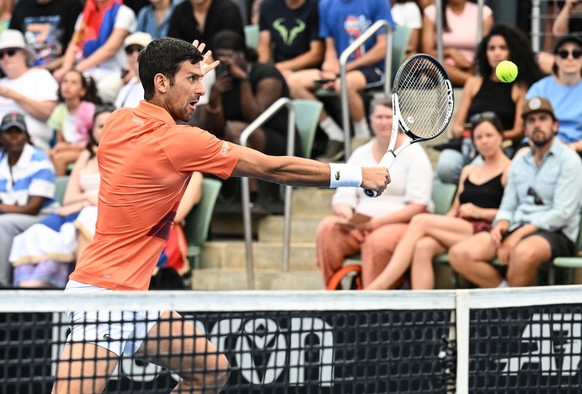 epa10385958 Novak Djokovic of Serbia hits a backhand volley in his first round doubles match during the 2023 Adelaide International Tennis Tournament at the Memorial Drive Tennis Centre in Adelaide, A ...