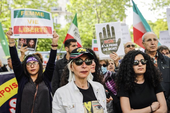epa10648634 People hold signs as they take part in a demonstration near the Iranian embassy in Paris, France, 23 May 2023. Civil society groups and human rights activists condemn the repression of the ...