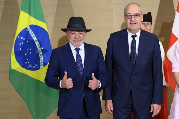 Swiss Federal President Guy Parmelin, right, speaks with Brazil's President Luiz Inacio Lula da Silva, left, prior to a bilateral meeting on the sideline of the the Evian G7 summit in Geneva, Swi ...