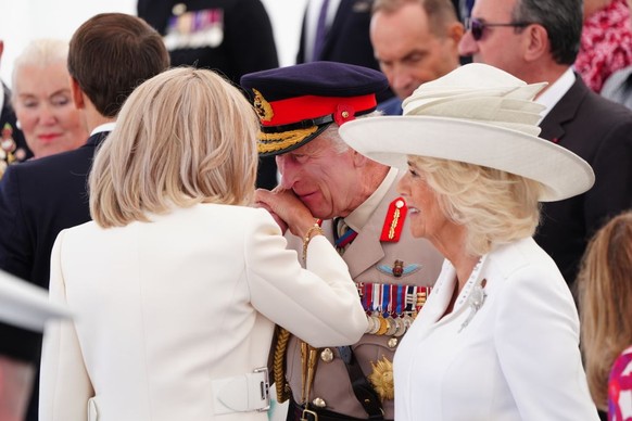 King Charles III greets French President Emmanuel Macron's wife Brigitte ahead of the UK national commemorative event for the 80th anniversary of D-Day, held at the British Normandy Memorial in V ...